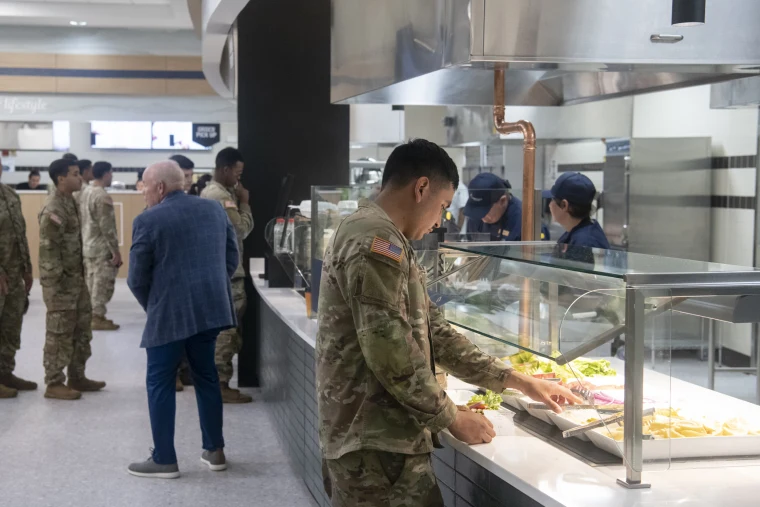 A soldier picks out toppings for his sandwich at Fort Drum, NY, on July 28, 2026.